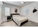 Bright bedroom featuring a ceiling fan, stylish decor, a grey rug, and natural light from the windows at 2496 Ram Crossing Way, Henderson, NV 89074