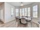 Bright dining area features multiple windows with plantation shutters and a modern chandelier at 2496 Ram Crossing Way, Henderson, NV 89074