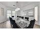 Formal dining room showcasing an elegant chandelier, a large mirror, and comfortable seating at 2496 Ram Crossing Way, Henderson, NV 89074