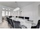 Dining area features a long table, pendant lighting, and plenty of space for entertaining at 2496 Ram Crossing Way, Henderson, NV 89074