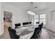 Cozy dining room featuring a modern light fixture, a large table, and view into kitchen at 2496 Ram Crossing Way, Henderson, NV 89074