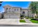Beautiful two-story home showcasing a three-car garage, arched windows, and a well-maintained front yard at 2496 Ram Crossing Way, Henderson, NV 89074