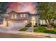 Stunning two-story home with a three-car garage, lush landscaping, and inviting entrance at 2496 Ram Crossing Way, Henderson, NV 89074