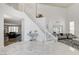 Grand foyer featuring marble floors, a staircase, and an open view into the living spaces at 2496 Ram Crossing Way, Henderson, NV 89074
