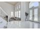 Bright and spacious foyer with marble flooring, high ceilings, and a view into the formal living room at 2496 Ram Crossing Way, Henderson, NV 89074