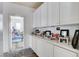 Hallway featuring built-in white cabinets and views of an adjacent bedroom at 2496 Ram Crossing Way, Henderson, NV 89074