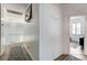 A hallway featuring modern light fixtures and access to rooms with natural light at 2496 Ram Crossing Way, Henderson, NV 89074