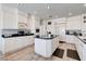 Bright kitchen features white cabinets, an island with a cooktop, and stainless steel appliances at 2496 Ram Crossing Way, Henderson, NV 89074