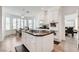 Kitchen featuring an island with cooktop, white cabinets, and a view to a dining area at 2496 Ram Crossing Way, Henderson, NV 89074