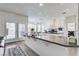 Open kitchen featuring a large island, stone countertops, and modern appliances at 2496 Ram Crossing Way, Henderson, NV 89074