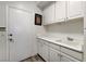 Functional laundry room offering practical cabinets, plenty of counter space, and convenient outside access at 2496 Ram Crossing Way, Henderson, NV 89074