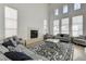 Light-filled living room with a fireplace, large windows, and comfortable seating, creating a cozy atmosphere at 2496 Ram Crossing Way, Henderson, NV 89074