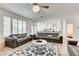 Open concept living room with modern furnishings and views of the kitchen and access to the patio at 2496 Ram Crossing Way, Henderson, NV 89074