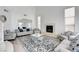 Elegant living room featuring a fireplace, tall windows, modern furniture, and a decorative rug at 2496 Ram Crossing Way, Henderson, NV 89074