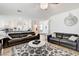 Open concept living room features contemporary design and seamless transition to the kitchen at 2496 Ram Crossing Way, Henderson, NV 89074