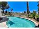 Inviting backyard pool features a spa and lush landscaping at 2496 Ram Crossing Way, Henderson, NV 89074
