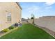 Manicured backyard features an artificial lawn, a small patio with new landscaping at 2833 Sangro Ct, Henderson, NV 89044