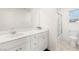 Bright bathroom with double sink vanity, a large mirror, and a shower over tub at 2833 Sangro Ct, Henderson, NV 89044