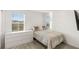 Modern bedroom with carpet flooring, two bright windows, and a large dresser at 2833 Sangro Ct, Henderson, NV 89044