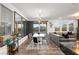 Dining and living room with large windows, modern lighting, and a view of the backyard at 2833 Sangro Ct, Henderson, NV 89044