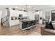 Modern kitchen featuring white cabinets, black granite counters, stainless steel appliances, and bar stool seating at 2833 Sangro Ct, Henderson, NV 89044