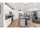 Open concept kitchen featuring white cabinets, marble countertops, a kitchen island, and stainless steel appliances at 2833 Sangro Ct, Henderson, NV 89044