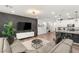 Open concept living space with modern kitchen, dining area and living room with accent wall at 2833 Sangro Ct, Henderson, NV 89044