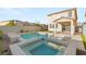 Stunning backyard pool with a raised spa, modern patio, and low-maintenance landscaping at 2833 Sangro Ct, Henderson, NV 89044