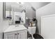 Functional bathroom with white vanity, mirror, toilet, and practical storage solutions at 2915 Cedar Ave # 11C, Las Vegas, NV 89101