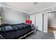 Light-filled bedroom with modern gray walls, soft carpet, and a convenient closet at 2915 Cedar Ave # 11C, Las Vegas, NV 89101