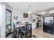 Open dining area with dark wood table, display cabinet, and adjacent kitchen space at 2915 Cedar Ave # 11C, Las Vegas, NV 89101