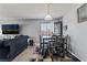 Open dining area featuring modern table set, TV, and access to the living room at 2915 Cedar Ave # 11C, Las Vegas, NV 89101