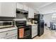 Efficient kitchen featuring white cabinets, black appliances, and an adjacent dining area at 2915 Cedar Ave # 11C, Las Vegas, NV 89101