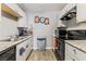 Well-maintained kitchen with white cabinets, granite counters, and modern appliances at 2915 Cedar Ave # 11C, Las Vegas, NV 89101