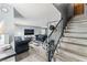 Open-concept living room with modern decor, sleek furniture, and staircase at 2915 Cedar Ave # 11C, Las Vegas, NV 89101