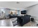 Relaxing living room with plush black sofas, a large TV, and a patterned rug on wood-look floors at 2915 Cedar Ave # 11C, Las Vegas, NV 89101