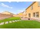 This backyard features well manicured grass, brick pavers, and a nice seating area at 3524 Colby Creek Ave, North Las Vegas, NV 89081