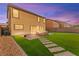 Cozy backyard featuring artificial grass, pavers, a stone border and an outdoor seating area at 3524 Colby Creek Ave, North Las Vegas, NV 89081
