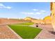 This backyard features well manicured grass, brick pavers, and a nice seating area at 3524 Colby Creek Ave, North Las Vegas, NV 89081
