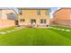Spacious backyard features manicured artificial grass, pavers, an outdoor seating area, and block walls at 3524 Colby Creek Ave, North Las Vegas, NV 89081