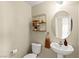 Charming half bath with pedestal sink, decorative mirror, and modern fixtures at 3524 Colby Creek Ave, North Las Vegas, NV 89081