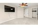 Bedroom features neutral walls, carpet, ceiling fan, mounted TV, walk-in closet and doorway to another room at 3524 Colby Creek Ave, North Las Vegas, NV 89081