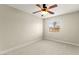 Bright bedroom featuring plush carpeting, a ceiling fan with light kit, and natural light from the window at 3524 Colby Creek Ave, North Las Vegas, NV 89081