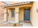 Charming front entry with covered porch and well-maintained landscaping with a nice blue front door at 3524 Colby Creek Ave, North Las Vegas, NV 89081