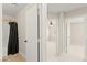 Hallway with carpeting, neutral walls, bathroom with shower-tub and bedrooms through open doorways at 3524 Colby Creek Ave, North Las Vegas, NV 89081