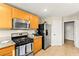 Modern kitchen featuring stainless steel appliances, light wood cabinets, and granite countertops at 3524 Colby Creek Ave, North Las Vegas, NV 89081