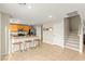Open kitchen space boasts stainless steel appliances, wood cabinetry and a convenient breakfast bar with seating at 3524 Colby Creek Ave, North Las Vegas, NV 89081