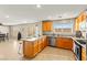 Bright kitchen with stainless steel appliances, granite counters, and a breakfast bar seamlessly flows to the backyard at 3524 Colby Creek Ave, North Las Vegas, NV 89081