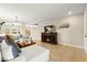Bright living room with tile floors, comfy gray sectional, and cozy fireplace at 3524 Colby Creek Ave, North Las Vegas, NV 89081