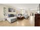 Spacious living room features a comfortable gray sectional sofa and neutral tile flooring at 3524 Colby Creek Ave, North Las Vegas, NV 89081